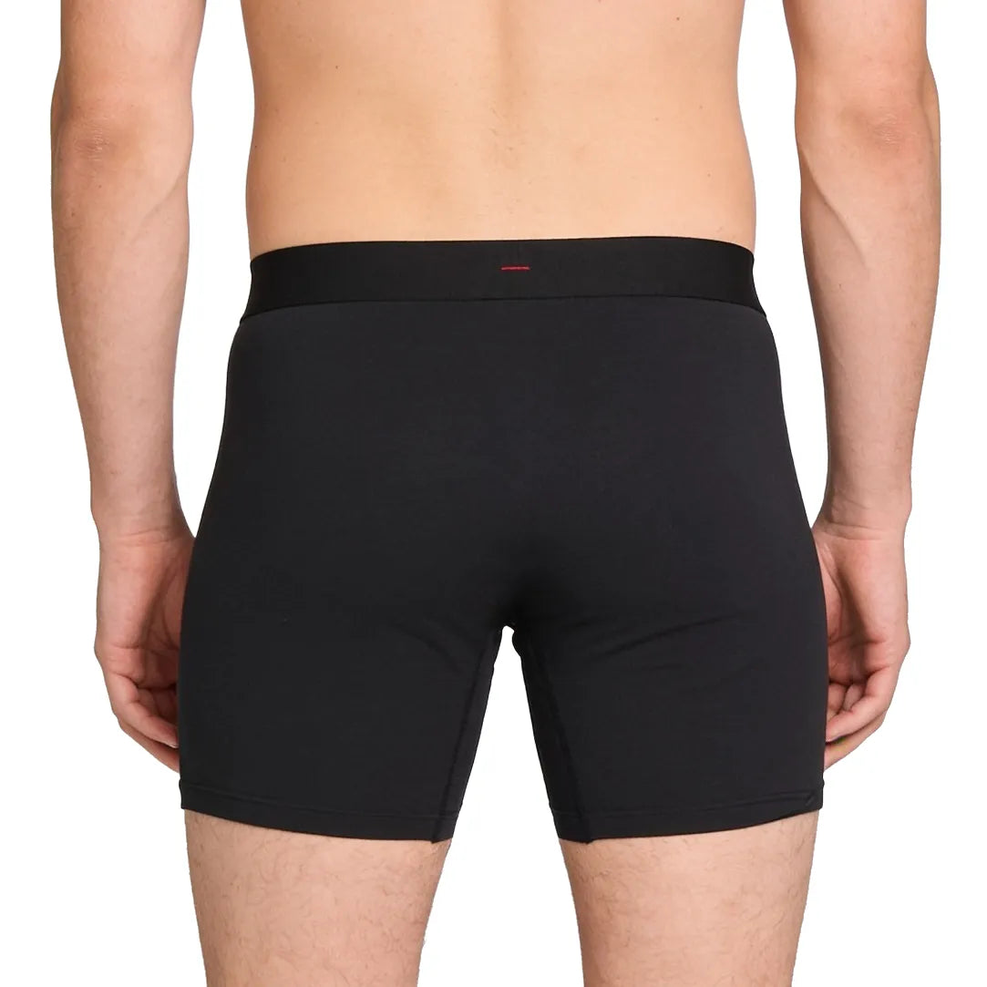 ātem boxer brief in black, worn from behind, showing the single red bar-tack on the waistband